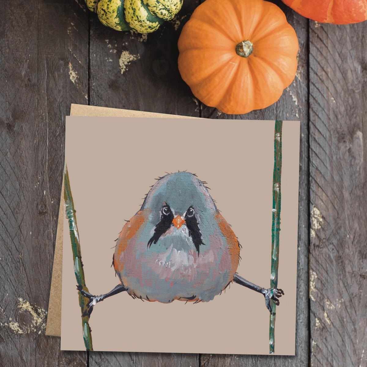 Square Fiddles the Bearded Tit art card displayed with a brown kraft envelope.