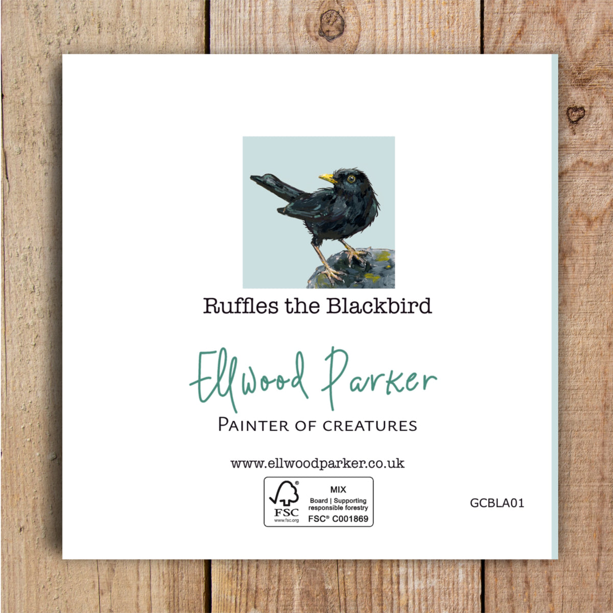 The back of a eco card featuring a blackbird painting with detailed, textured feathers and a bright yellow beak. Ellwood Parker, painter of creatures is printed on the back.