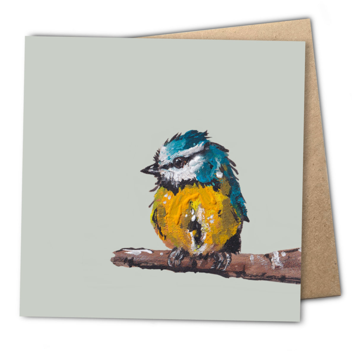 A detailed painting of a blue tit bird with bright blue, yellow, and green feathers, perched on a branch. Printed on a blank square greetings card displayed alongside a textured kraft envelope.