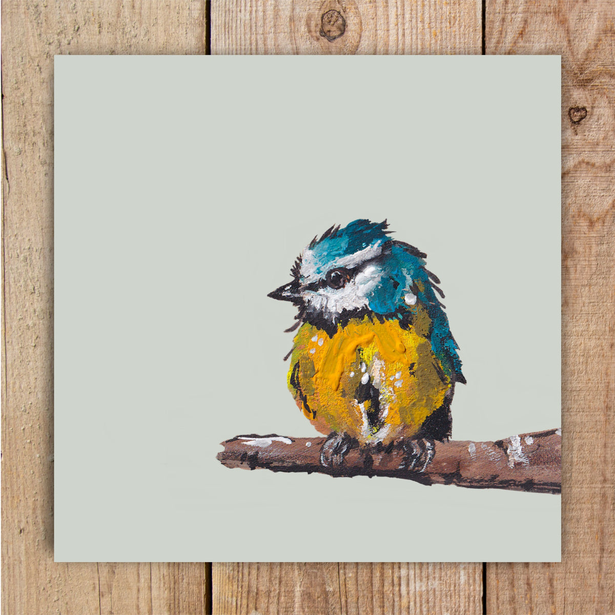 A wildlife painting of a vibrant blue tit named Ken, featured on a square greetings card.